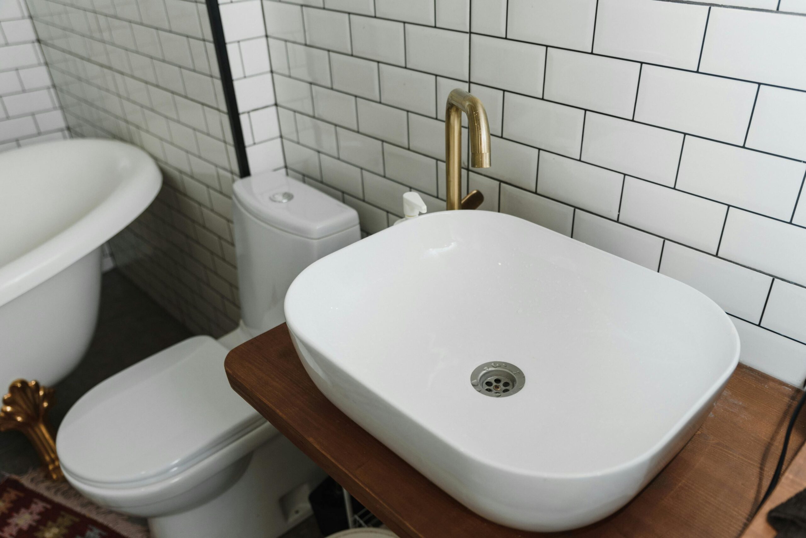 Stylish bathroom interior featuring a ceramic sink, bathtub, and modern fixtures.